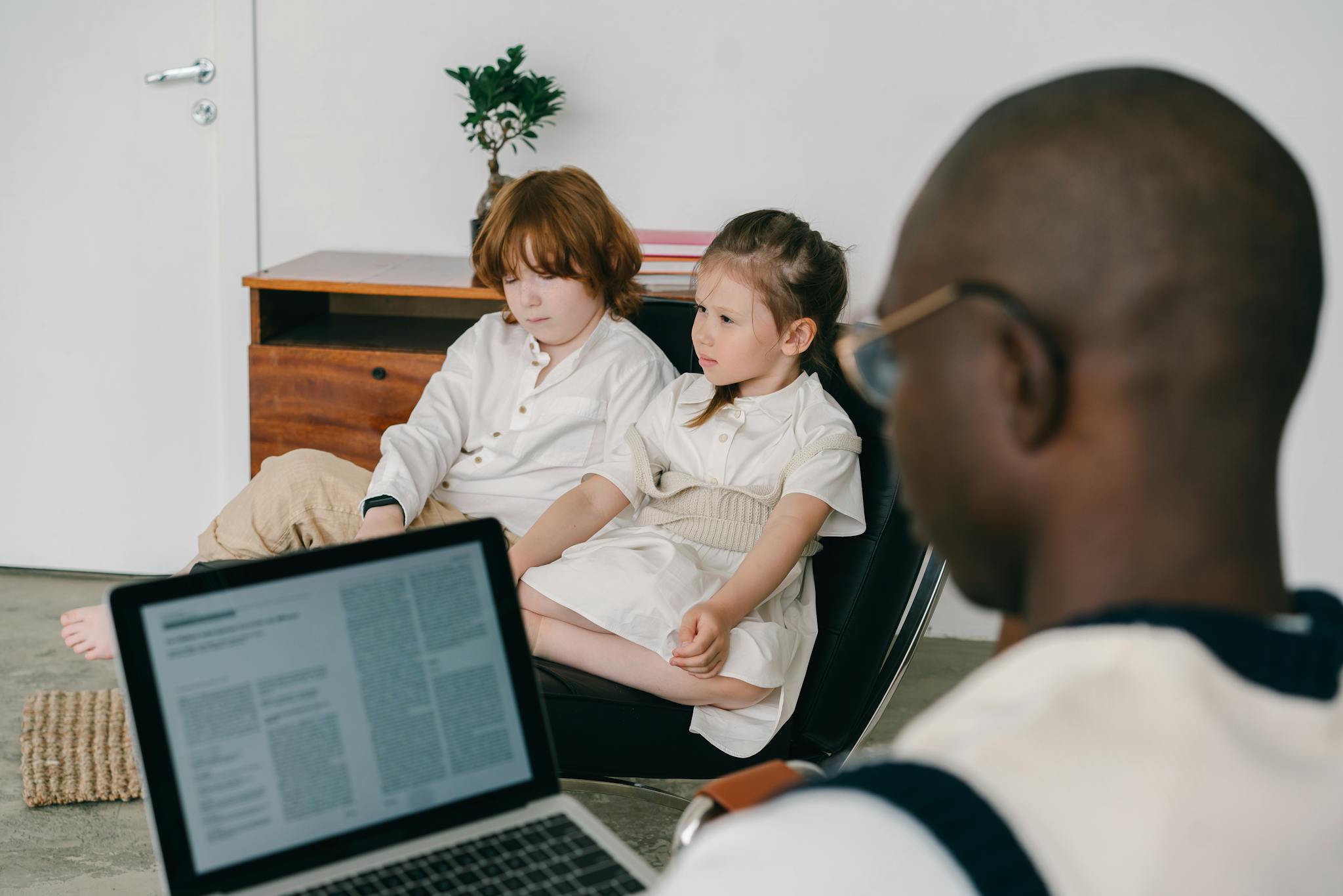 ABA Therapy Clinic, Therapist working with two children in an indoor therapy session, focusing on mental health.